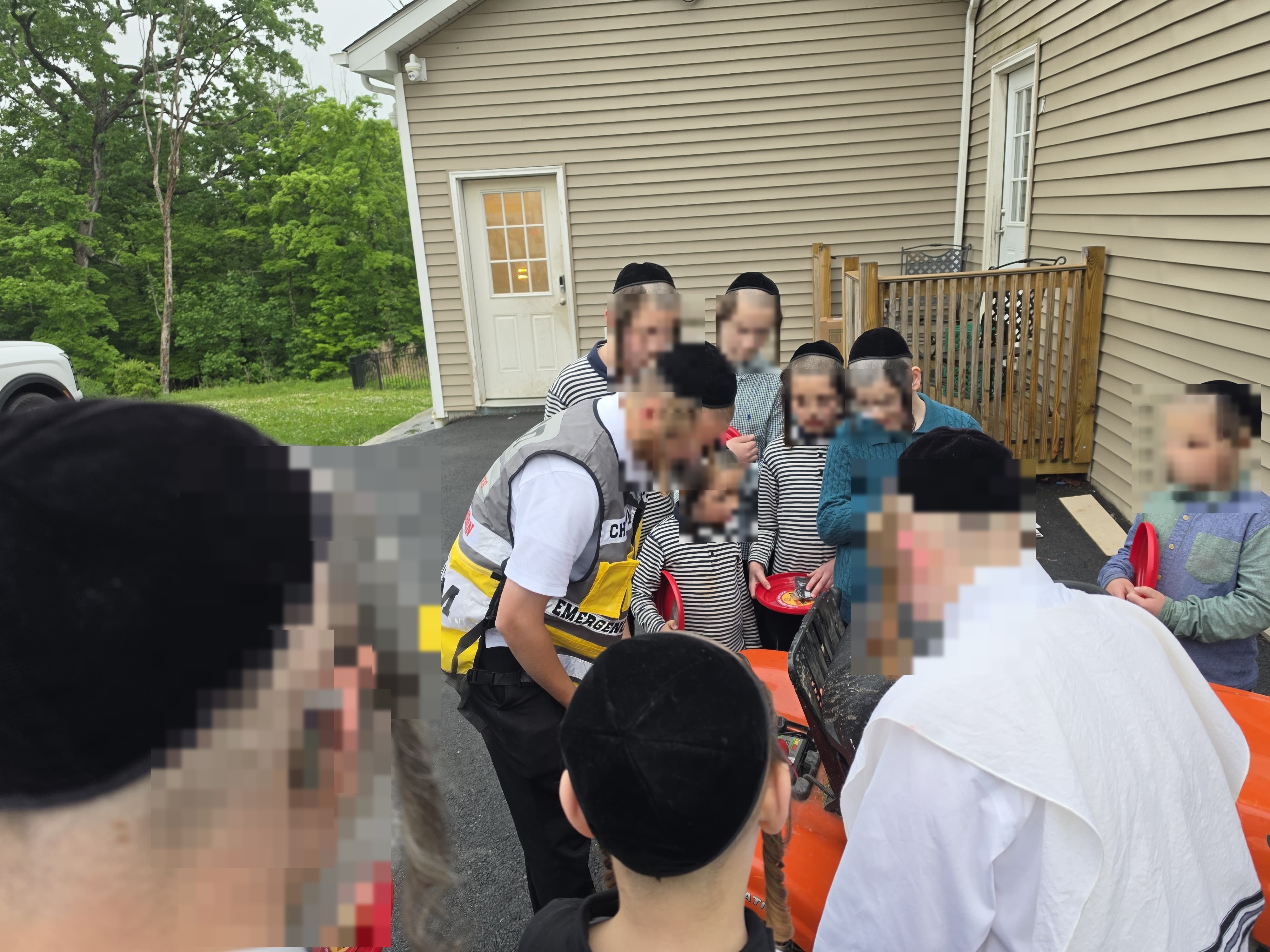 An Orange County Chavivim member demonstrating response equipment to a group of children from Achyim B'Yachad