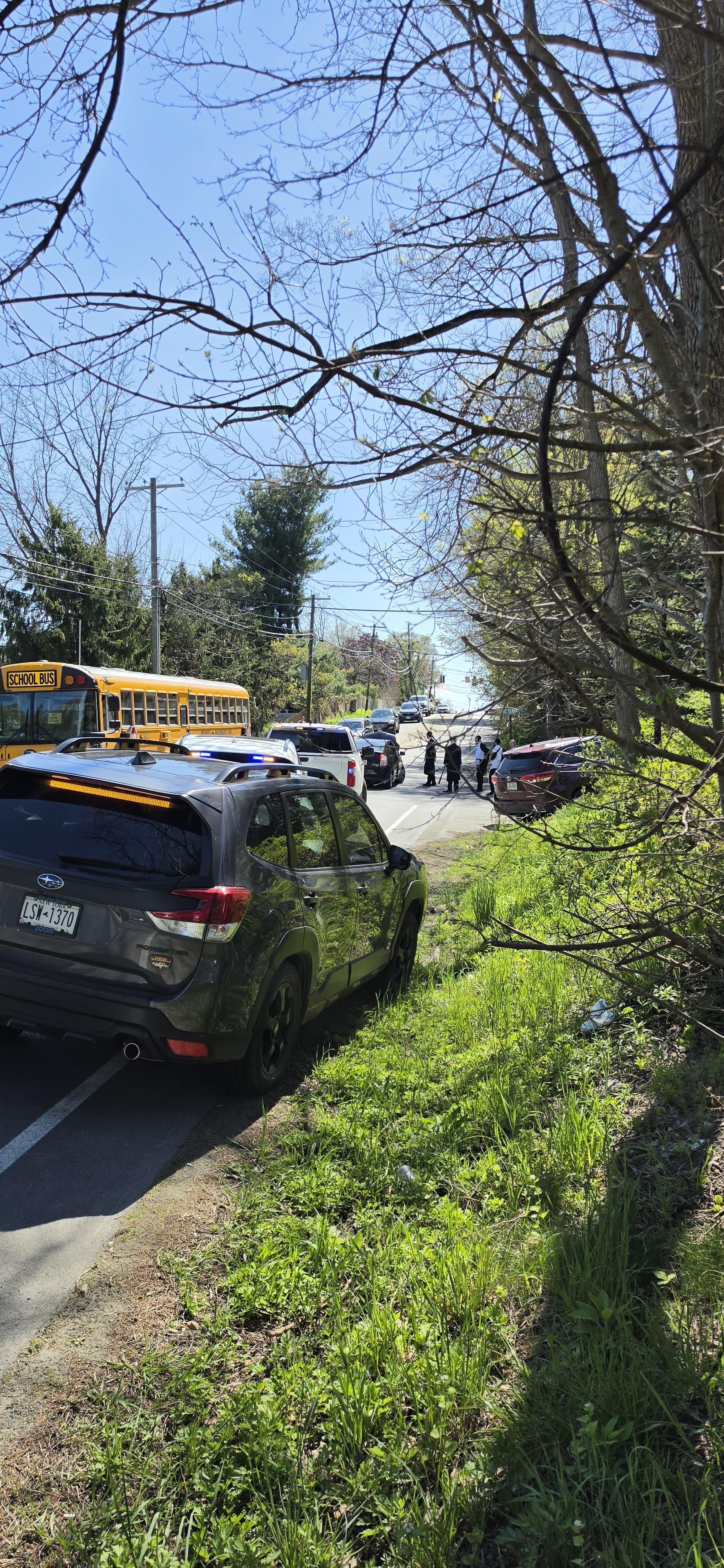 Traffic backed up behind the stalled vehicle on CR 105, including a school bus