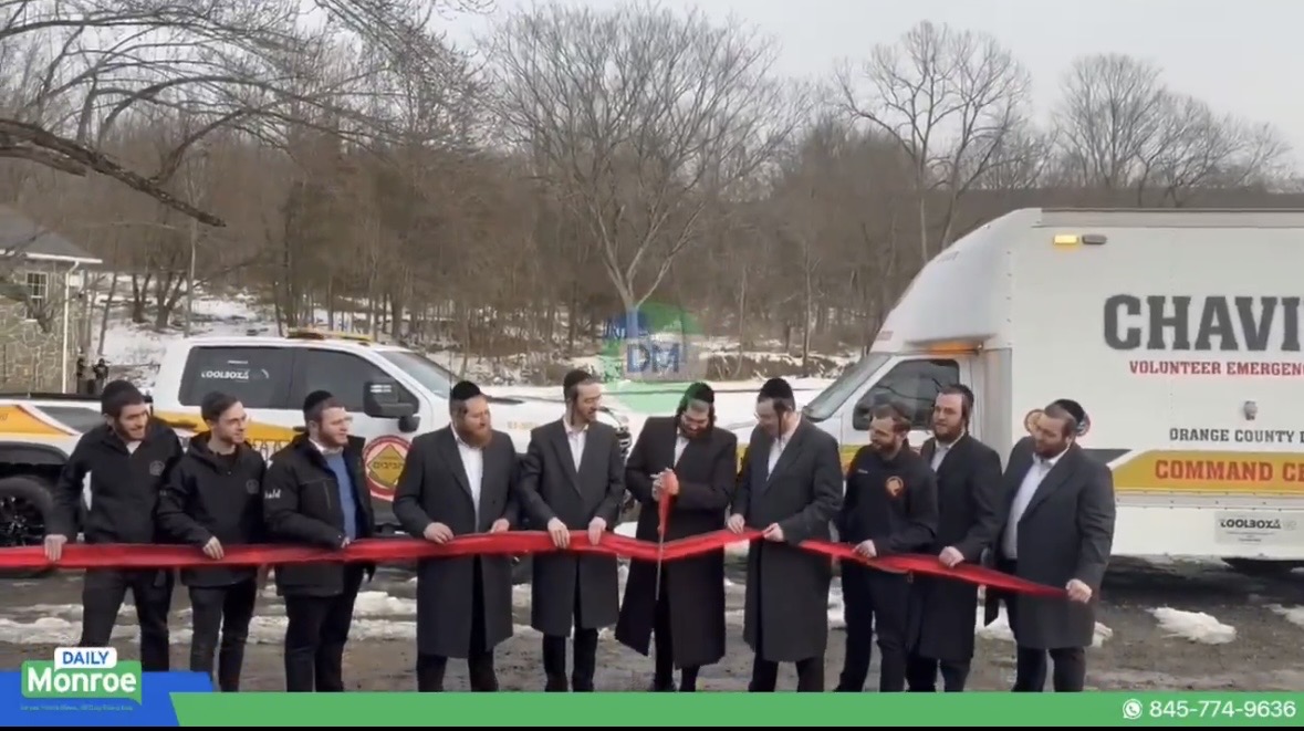 Wide shot of the ribbon cutting ceremony with the Chavivim command center truck behind the crowd