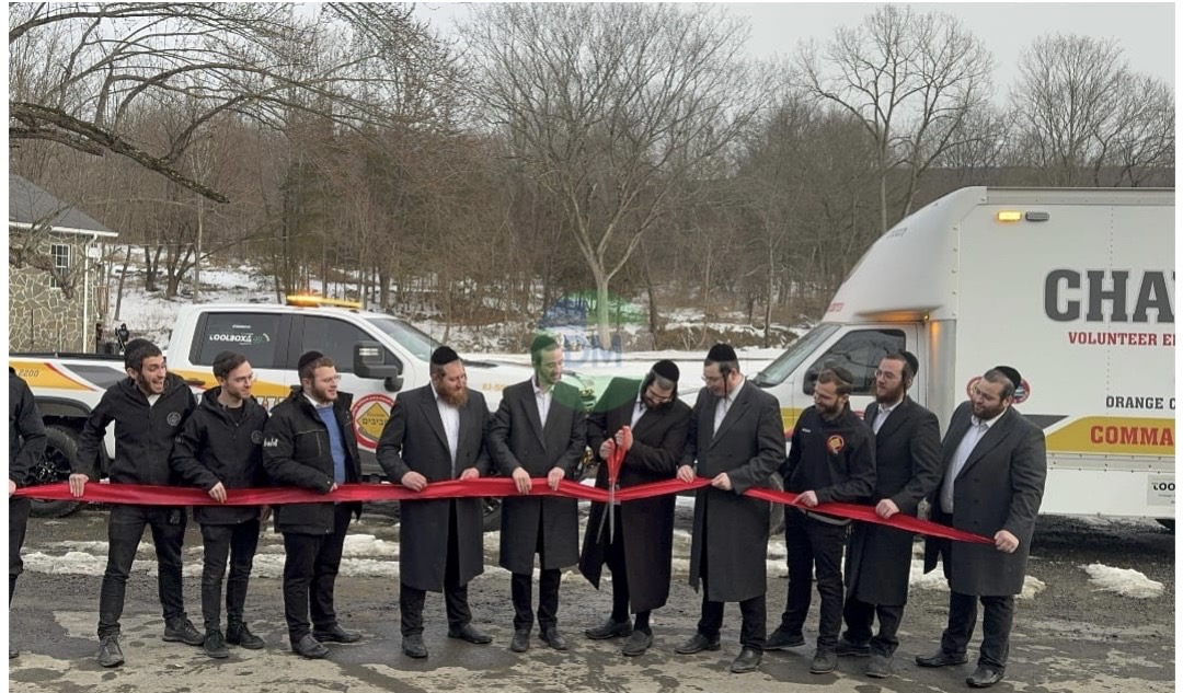 Members and leadership cutting the ribbon at the official unveiling of KJ-500 and KJ-503 with the command center truck in the background