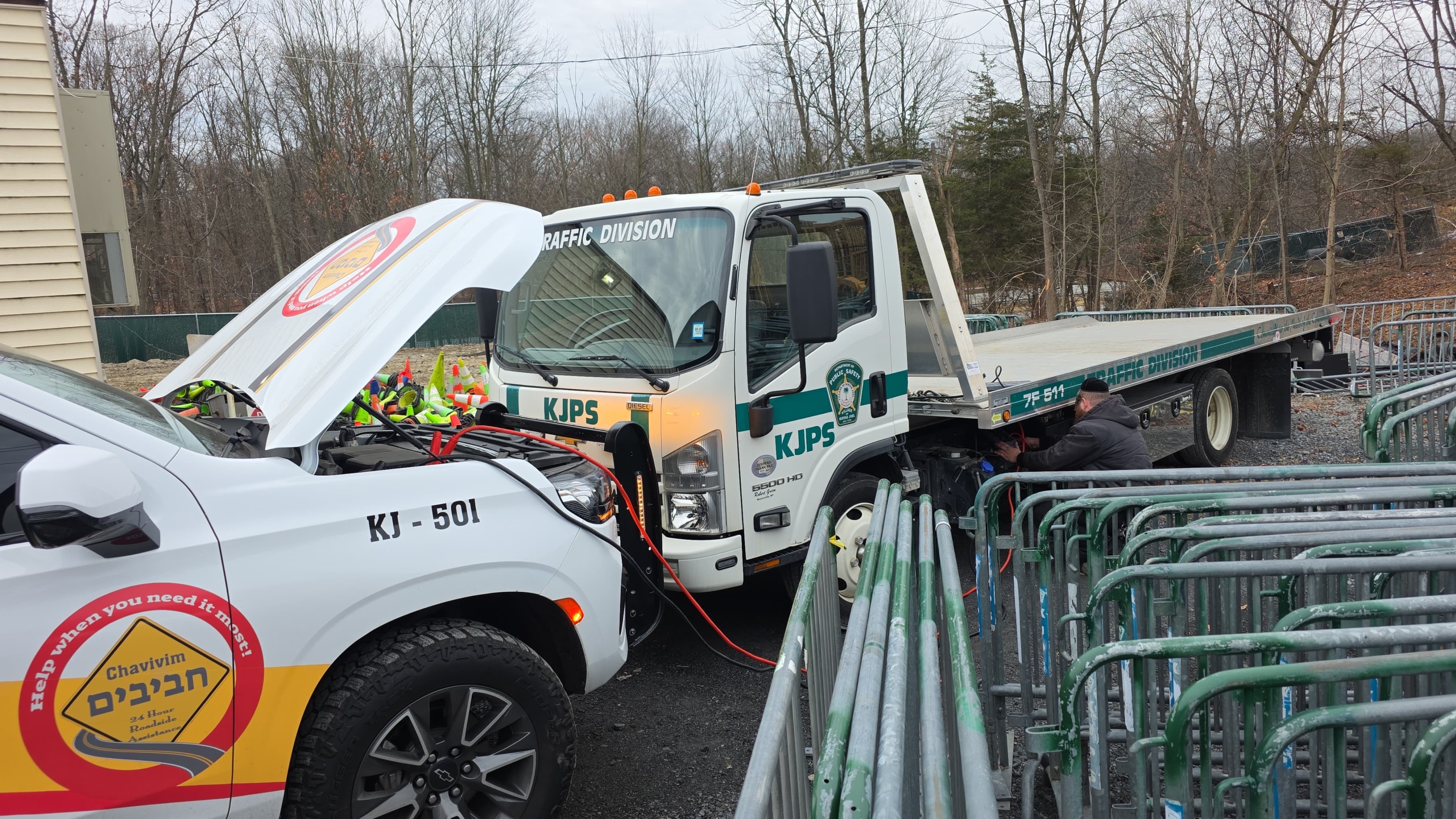 Chavivim KJ-501 alongside a Kiryas Joel Public Safety Traffic Division truck with jumper cables connected
