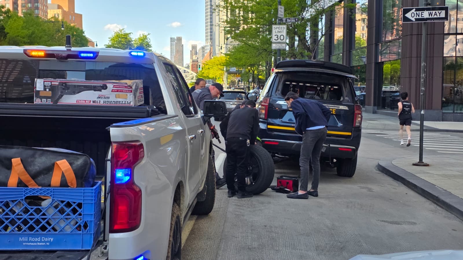 Chavivim Changes a Blown Tire on an NYSP Cruiser in Lower Manhattan