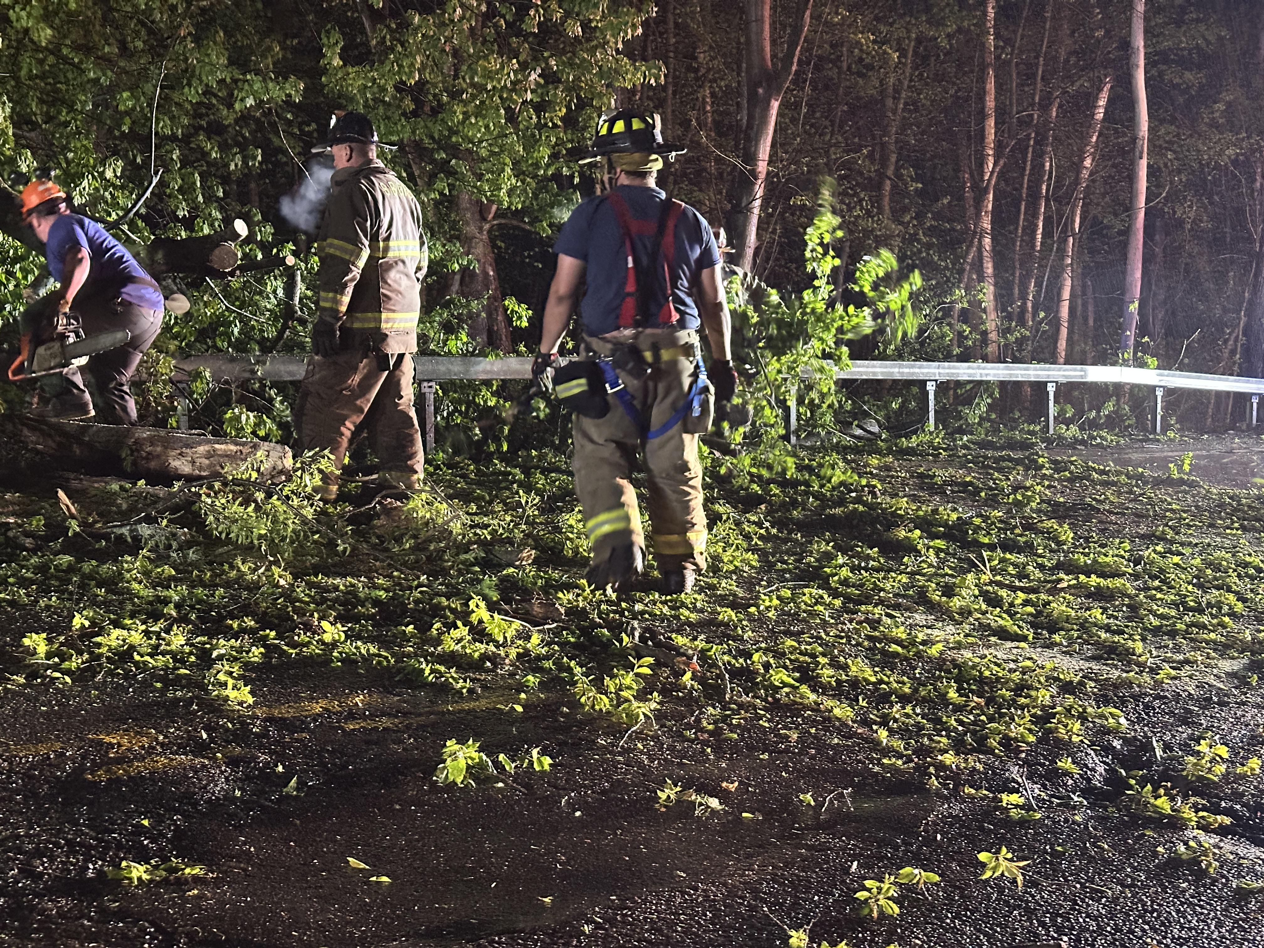 South Blooming Grove firefighters cutting up downed trees with chainsaws on Route 208