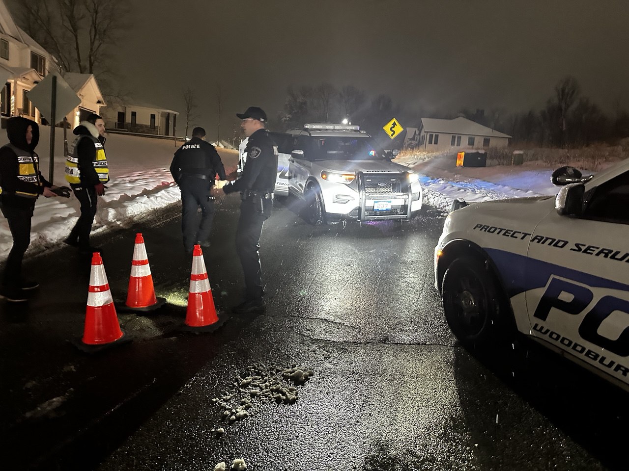 Orange County Chavivim members on scene with Woodbury PD securing a displaced manhole cover at night