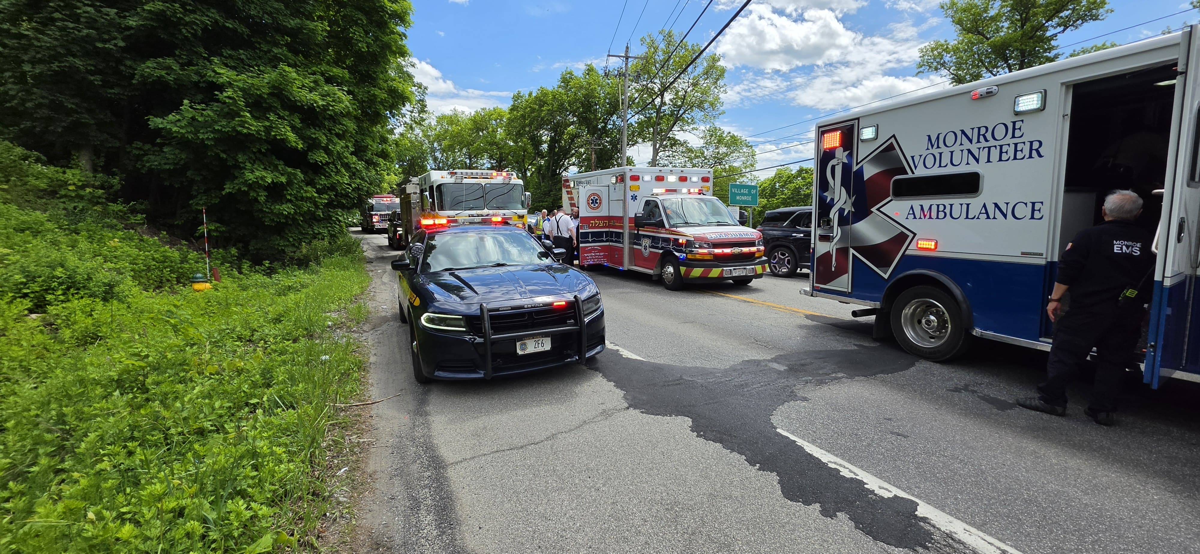An ambulance staged down the road as Chavivim members hold traffic at the second crash scene