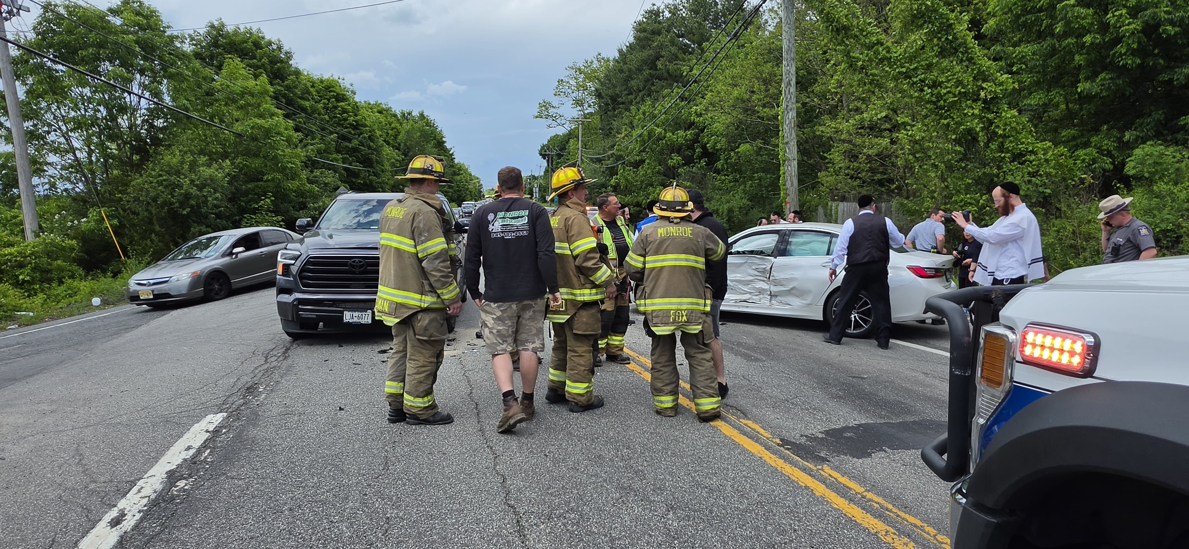 Monroe firefighters and Chavivim members in the roadway running traffic control during the second crash response