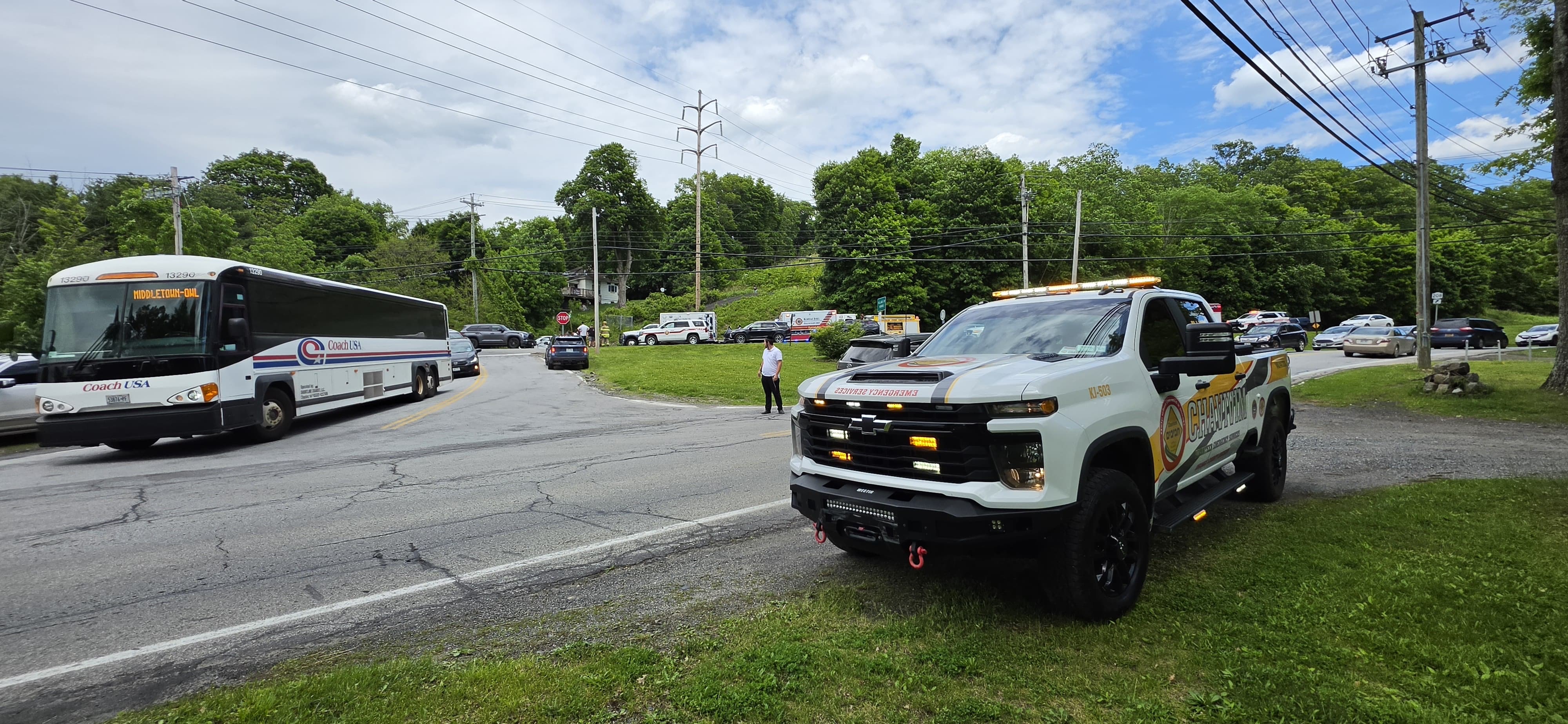Traffic backed up at the corner with a passenger bus while KJ-503 and members manage the second crash scene